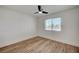 Bedroom features a ceiling fan, wood-look floors, and a window with privacy blinds at 8813 Sundial Dr, Las Vegas, NV 89134