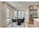 Bright dining area adjacent to the kitchen features a modern table, large windows, and access to the backyard at 8813 Sundial Dr, Las Vegas, NV 89134
