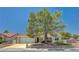 Attractive home exterior with a large tree in the front yard, two-car garage, and easy access to nearby neighborhoods at 8813 Sundial Dr, Las Vegas, NV 89134
