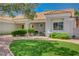 Well-manicured front yard featuring desert landscaping, a green lawn, and comfortable seating on the front patio at 8813 Sundial Dr, Las Vegas, NV 89134