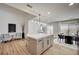 Bright modern kitchen featuring an island with seating, stainless steel appliances, and an adjacent sitting area at 8813 Sundial Dr, Las Vegas, NV 89134