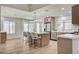 Modern kitchen featuring an island with seating, stainless steel appliances, and wood-look floors at 8813 Sundial Dr, Las Vegas, NV 89134
