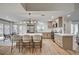 Spacious kitchen featuring a large island with seating, stainless steel appliances, and wood-look floors at 8813 Sundial Dr, Las Vegas, NV 89134