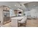 Bright open kitchen featuring an island with seating, stainless steel appliances, and a seamless flow to living area at 8813 Sundial Dr, Las Vegas, NV 89134