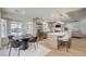 Open-concept kitchen and dining area with stainless steel appliances, modern island, and adjacent living space at 8813 Sundial Dr, Las Vegas, NV 89134