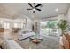 Bright living room features an open floor plan, a sliding glass door to the backyard, and modern decor at 8813 Sundial Dr, Las Vegas, NV 89134