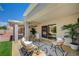 Covered patio with comfortable seating area, an outdoor rug, and sliding glass door entry at 8813 Sundial Dr, Las Vegas, NV 89134
