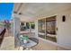 The covered patio features sliding glass doors, a small seating set, and a potted plant at 8813 Sundial Dr, Las Vegas, NV 89134