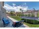 Inviting backyard featuring a trampoline, lounge seating, and lush landscaping at 8820 Fall Green Ave, Las Vegas, NV 89129