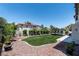 Lush backyard featuring manicured lawn, garden beds, and an inviting outdoor seating area at 8820 Fall Green Ave, Las Vegas, NV 89129