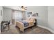 Cozy bedroom features a ceiling fan, desk, area rug, and natural light from the exterior window at 8820 Fall Green Ave, Las Vegas, NV 89129