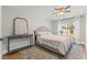 Bright bedroom features a ceiling fan, area rug, and natural light from the exterior window at 8820 Fall Green Ave, Las Vegas, NV 89129