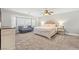 Spacious bedroom showcasing a large bed with an upholstered headboard and a cozy seating area at 8820 Fall Green Ave, Las Vegas, NV 89129