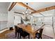Dining room with wooden table, chandelier, and view into the bright, modern kitchen at 8820 Fall Green Ave, Las Vegas, NV 89129