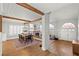 Dining area featuring wood floors, vaulted ceilings, beams, and adjacent living room at 8820 Fall Green Ave, Las Vegas, NV 89129