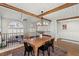 Open concept dining area with wooden table and chairs and view of the living area at 8820 Fall Green Ave, Las Vegas, NV 89129