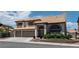 Two-story home with a tile roof, a three-car garage, and mature landscaping at 8820 Fall Green Ave, Las Vegas, NV 89129