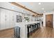 Spacious kitchen with large island, white cabinets, wood flooring, and stylish pendant lighting at 8820 Fall Green Ave, Las Vegas, NV 89129