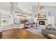 Bright living room with hardwood floors, fireplace, ceiling fan, and staircase at 8820 Fall Green Ave, Las Vegas, NV 89129
