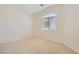 Bright bedroom featuring neutral carpet, paint and window letting in natural light at 9252 Oxbow Lake Ave, Las Vegas, NV 89149
