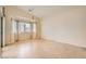 Spacious dining room featuring tiled floor, large window, curtains, and chandelier at 9252 Oxbow Lake Ave, Las Vegas, NV 89149