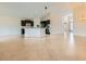 Spacious living space with tile floors and open layout to kitchen at 9252 Oxbow Lake Ave, Las Vegas, NV 89149