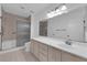 A bathroom featuring a shower over tub, a toilet, and a large vanity with a big mirror at 9424 Gold Mountain Dr, Las Vegas, NV 89134