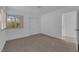 Bedroom features neutral carpet, and a large window with views of the outside at 9424 Gold Mountain Dr, Las Vegas, NV 89134