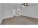 Carpeted primary bedroom features a ceiling fan and entry to bathroom at 9424 Gold Mountain Dr, Las Vegas, NV 89134