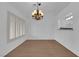 Dining room with wood floors, a modern chandelier, and access to the kitchen through a pass-through at 9424 Gold Mountain Dr, Las Vegas, NV 89134