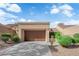 Charming one-story home features an attached garage, desert landscaping, and a well-maintained exterior at 9424 Gold Mountain Dr, Las Vegas, NV 89134