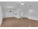 Bright living room with wood floors, a ceiling fan, and neutral walls; the kitchen pass-through is visible at 9424 Gold Mountain Dr, Las Vegas, NV 89134