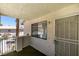 Balcony with desert landscaping, an iron railing and a security screen door at 1013 Falconhead Ln # 202, Las Vegas, NV 89128