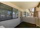 Balcony view of a stucco condo with window and screen doors at 1013 Falconhead Ln # 202, Las Vegas, NV 89128