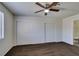 Neutral bedroom with ceiling fan, a sliding closet, and an ensuite bathroom at 1013 Falconhead Ln # 202, Las Vegas, NV 89128