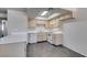 Kitchen boasts tile flooring, bright skylight, and white appliances at 1013 Falconhead Ln # 202, Las Vegas, NV 89128