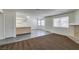 Open concept living room featuring tile floors, natural light, and brick fireplace at 1013 Falconhead Ln # 202, Las Vegas, NV 89128