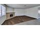 Living room showcases a classic brick fireplace, neutral walls, and cozy carpet at 1013 Falconhead Ln # 202, Las Vegas, NV 89128
