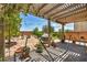 Shaded patio area in the backyard with desert landscaping and various potted plants and decor at 10312 Glimmering Star Dr, Las Vegas, NV 89178