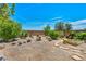 Large backyard with desert landscaping, shrubbery, and rock features, ready for personalization at 10312 Glimmering Star Dr, Las Vegas, NV 89178