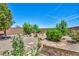 Spacious backyard with desert landscaping, shrubbery, and rock features, a beautiful outdoor space at 10312 Glimmering Star Dr, Las Vegas, NV 89178