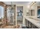 Modern bathroom featuring a tiled shower with rainfall showerhead and double sink vanity at 10312 Glimmering Star Dr, Las Vegas, NV 89178