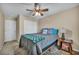Cozy bedroom with a ceiling fan, closet, and a side table with books at 10312 Glimmering Star Dr, Las Vegas, NV 89178