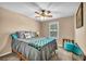 Cozy bedroom featuring ceiling fan, window with blinds, and queen size bed at 10312 Glimmering Star Dr, Las Vegas, NV 89178