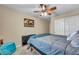 Inviting bedroom with ceiling fan, closet, and a comfortable full sized bed at 10312 Glimmering Star Dr, Las Vegas, NV 89178