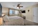 Bright bedroom featuring a window with plantation shutters and a ceiling fan at 10312 Glimmering Star Dr, Las Vegas, NV 89178