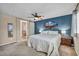 Inviting bedroom featuring an accent wall, ensuite and side tables at 10312 Glimmering Star Dr, Las Vegas, NV 89178