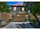 Charming two-story home with a two-car garage with stone accents and dark shutters at 10312 Glimmering Star Dr, Las Vegas, NV 89178