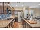 Well-lit kitchen featuring granite countertops, stainless steel appliances, and tile backsplash at 10312 Glimmering Star Dr, Las Vegas, NV 89178