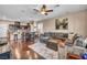 Open concept living room and kitchen featuring hardwood floors and plenty of seating at 10312 Glimmering Star Dr, Las Vegas, NV 89178